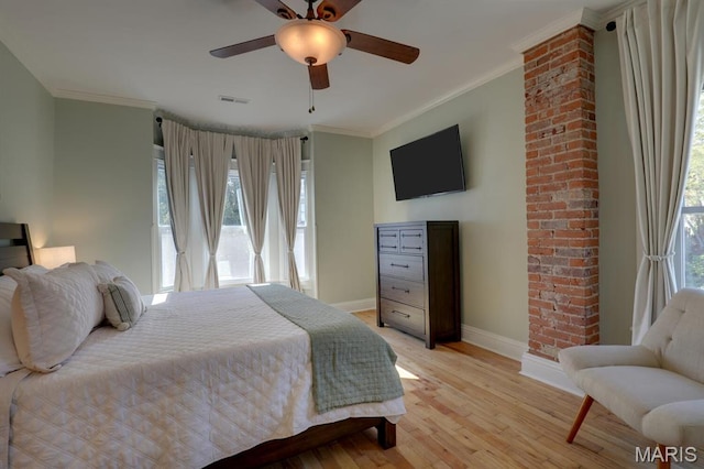 bedroom with baseboards, crown molding, light wood finished floors, and ceiling fan