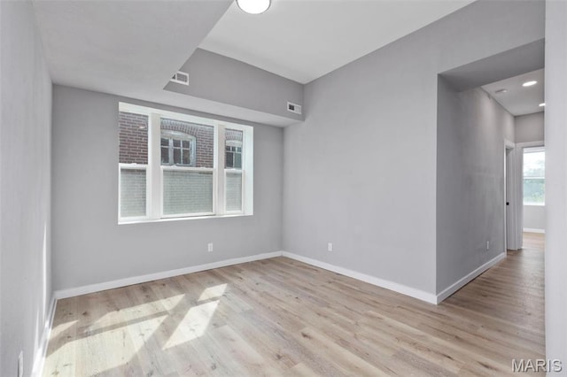 empty room with wood finished floors and baseboards