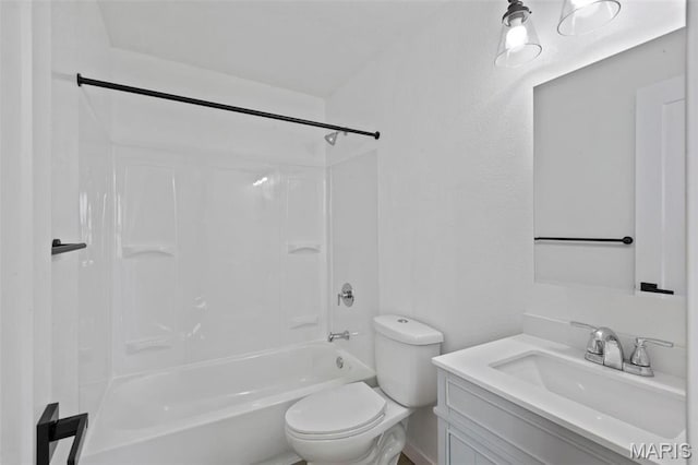 bathroom featuring toilet, vanity, and bathing tub / shower combination