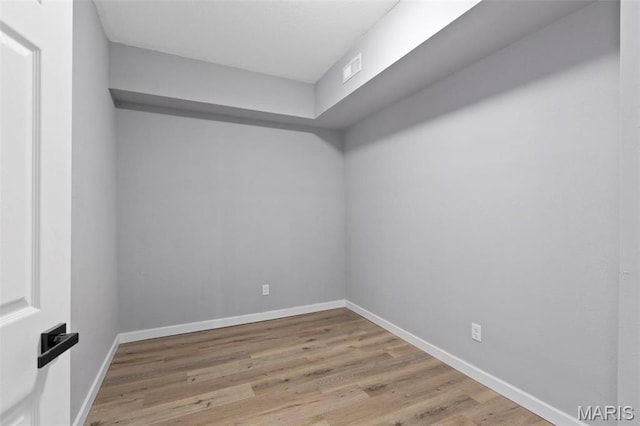 spare room featuring wood finished floors and baseboards