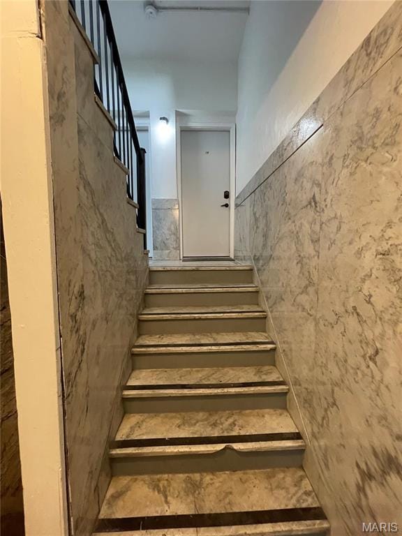 stairs with tile walls