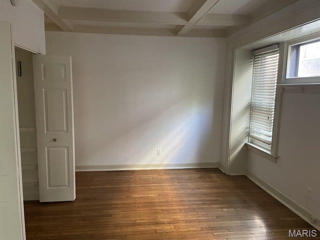 spare room featuring hardwood / wood-style flooring, beam ceiling, baseboards, and coffered ceiling