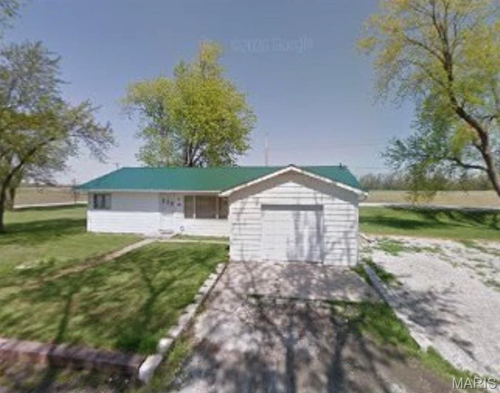 view of front facade with a front lawn and a garage