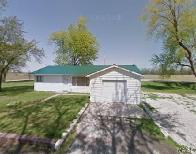 view of front facade with a front lawn and a garage