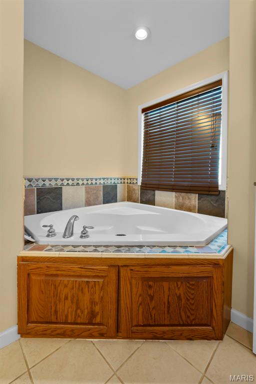 661 County Highway 261, Oran, MO 63771 - full bathroom with tile patterned floors, a garden tub, and baseboards