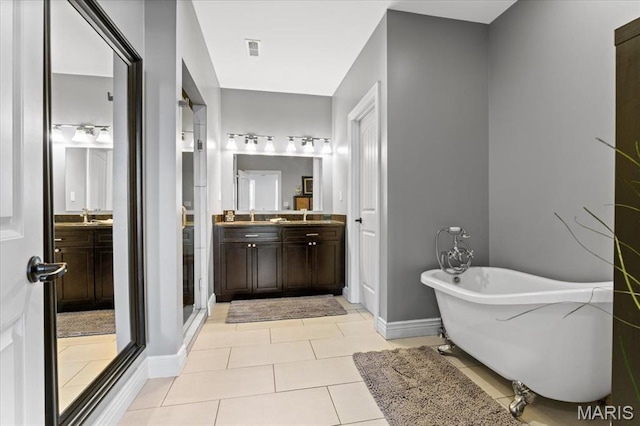 3884 Wyoming St, Saint Louis, MO 63116 - bathroom featuring a freestanding tub, baseboards, vanity, and tile patterned floors