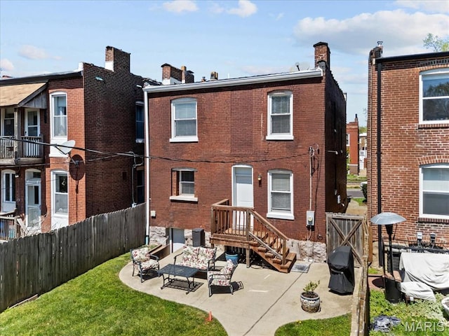3884 Wyoming St, Saint Louis, MO 63116 - back of house with a patio area, a chimney, a fenced backyard, and an outdoor living space