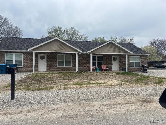 329 Rutledge St, Worden, IL 62097 - view of front facade featuring brick siding and covered porch