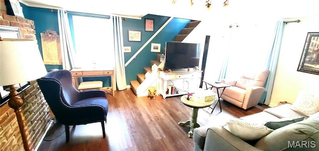 living area with stairs and wood finished floors