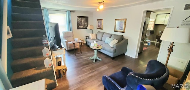 living room with wood finished floors and stairs