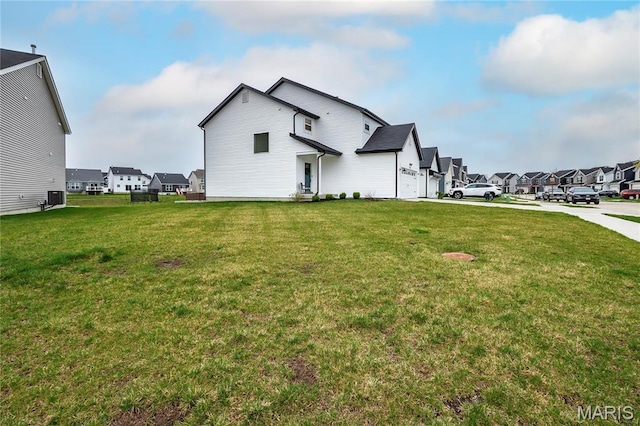 view of property exterior with a residential view and a yard