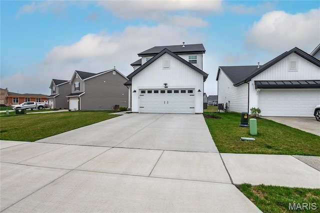 view of front of house with board and batten siding, a front lawn, concrete driveway, and a garage