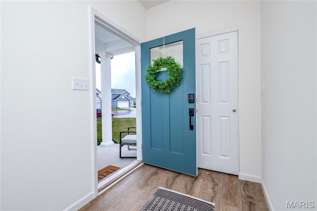 entrance foyer featuring wood finished floors and baseboards