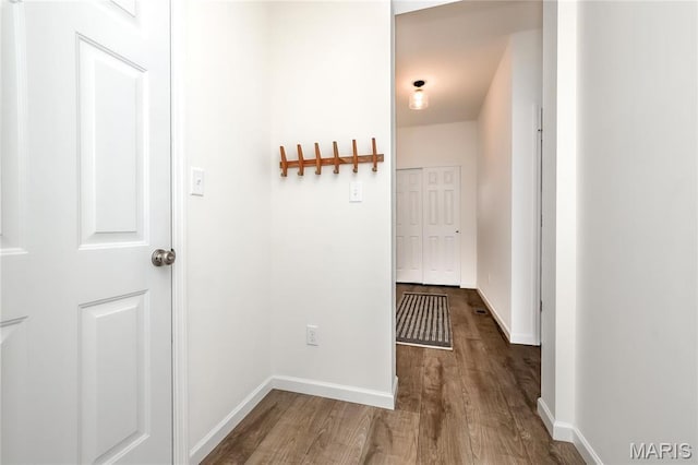hall with wood finished floors and baseboards