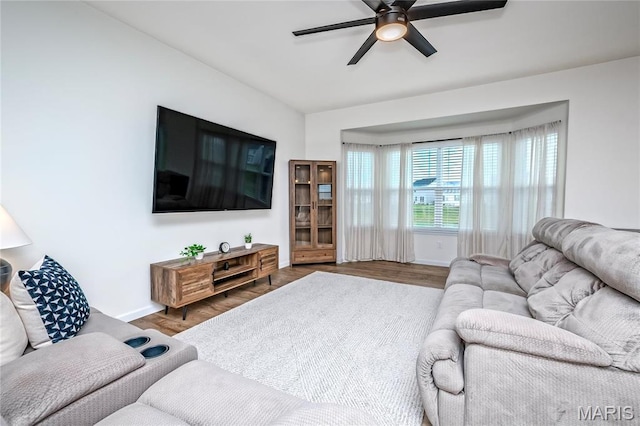 living area with ceiling fan, wood finished floors, and baseboards