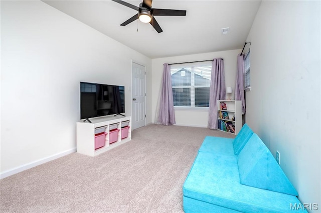 living room with ceiling fan, carpet floors, and baseboards