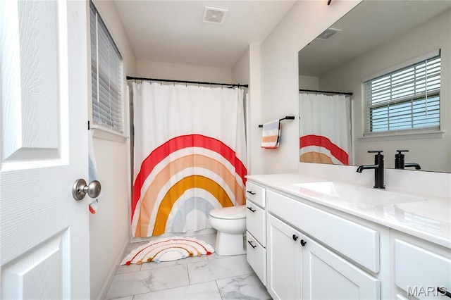 bathroom featuring marble finish floors, vanity, toilet, and a shower with curtain
