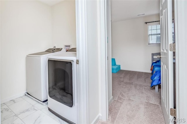 laundry area with washer and dryer, baseboards, and carpet