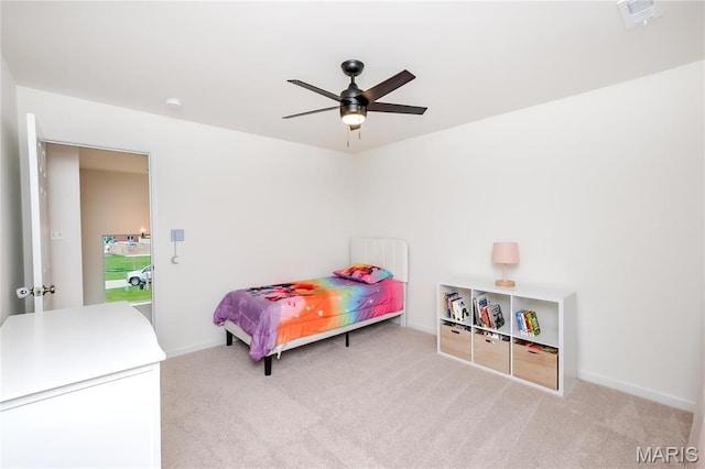 carpeted bedroom featuring baseboards and ceiling fan