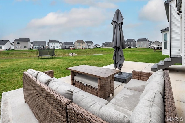 view of patio / terrace with an outdoor living space, a residential view, and a trampoline