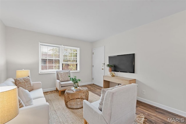 living area with wood finished floors and baseboards