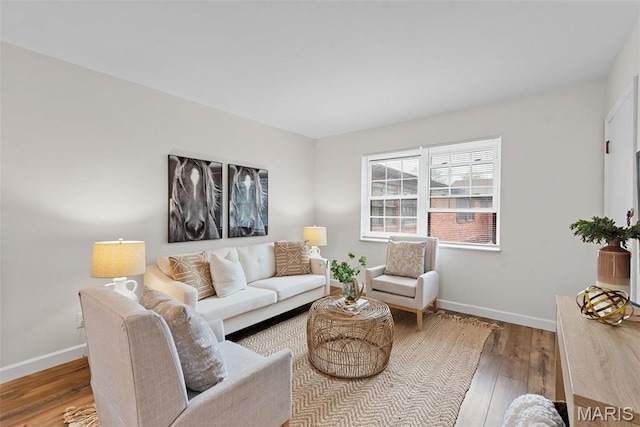 living area featuring hardwood / wood-style flooring and baseboards