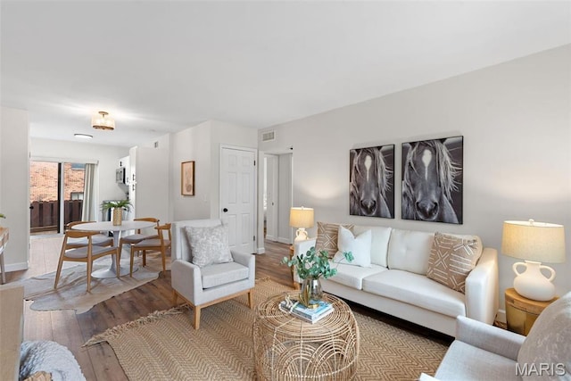 living area with hardwood / wood-style floors and baseboards
