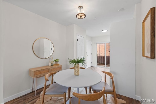 dining room featuring wood finished floors and baseboards