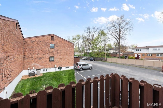 view of yard featuring central air condition unit and fence