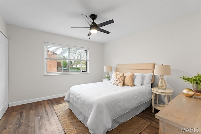 bedroom featuring baseboards, wood finished floors, and ceiling fan
