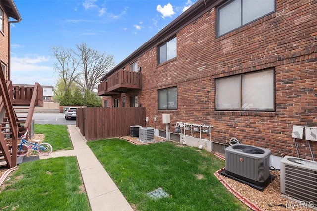 view of yard featuring cooling unit and stairs