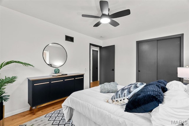 1015 Louisville Ave, Saint Louis, MO 63139 - bedroom with light wood finished floors, a closet, baseboards, and ceiling fan