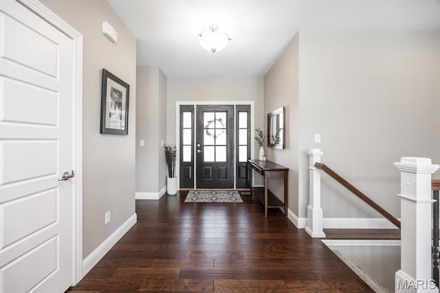entrance foyer featuring baseboards and hardwood / wood-style floors