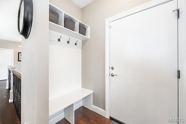 mudroom featuring dark wood finished floors and baseboards