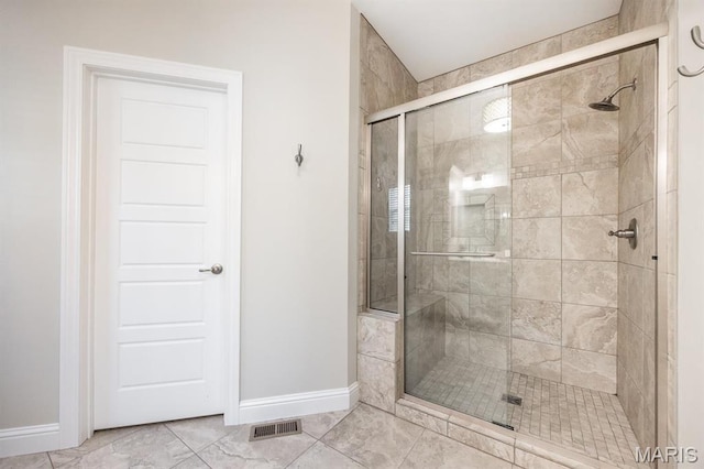 full bath featuring baseboards and a stall shower