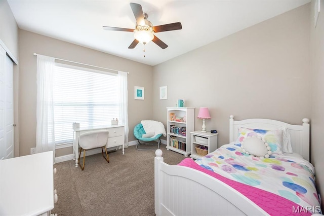 carpeted bedroom featuring multiple windows, baseboards, a closet, and a ceiling fan