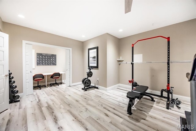 exercise area featuring wood finished floors, baseboards, and recessed lighting