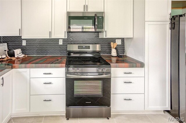 731 Dugger St, Bethalto, IL 62010 - kitchen featuring appliances with stainless steel finishes, white cabinetry, and decorative backsplash