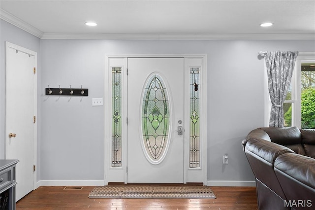 entryway featuring dark wood finished floors, crown molding, baseboards, and recessed lighting