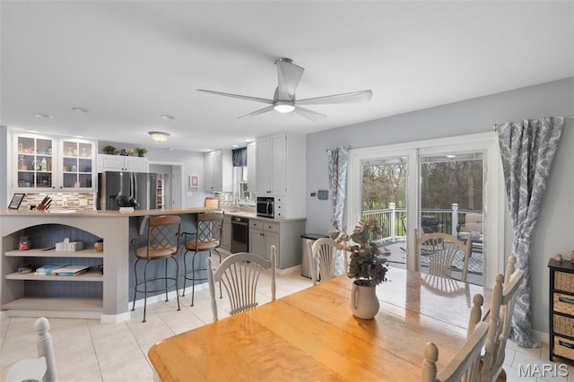 dining room featuring light tile patterned floors and ceiling fan