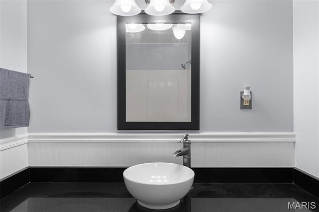 bathroom featuring wainscoting and a sink