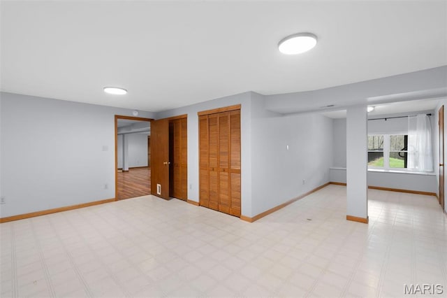 below grade area with baseboards and light flooring