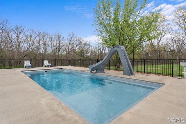 view of pool with a water slide, fence, a patio, and a sink