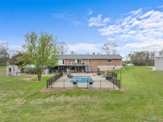 rear view of property featuring a storage unit, a patio, brick siding, an outdoor structure, and a wooden deck