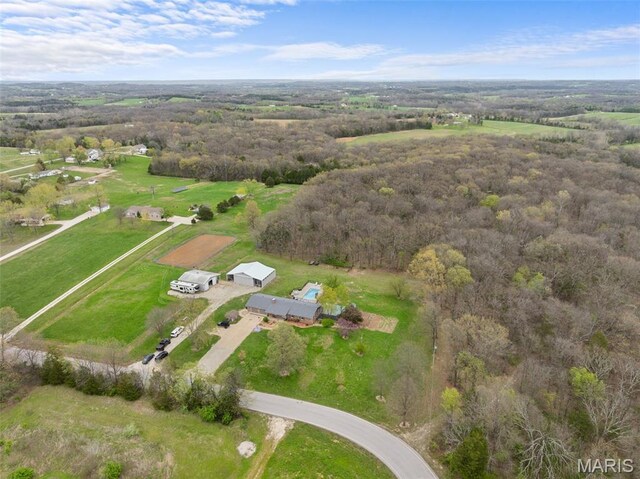 aerial overview of property's location with a forest