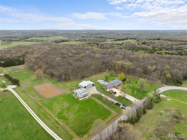 aerial overview of property's location with a heavily wooded area