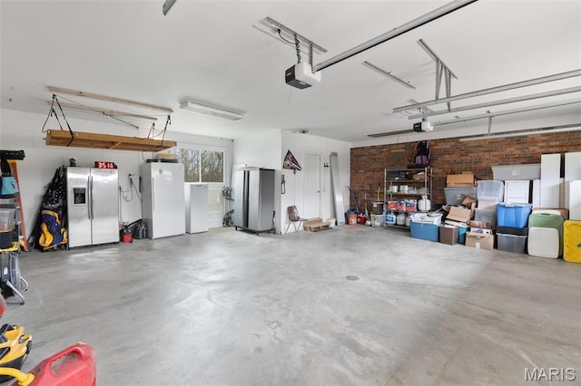 garage featuring stainless steel fridge with ice dispenser, freestanding refrigerator, and a garage door opener