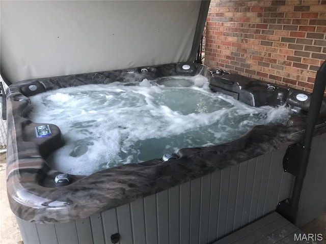 exterior view of a hot tub and brick siding