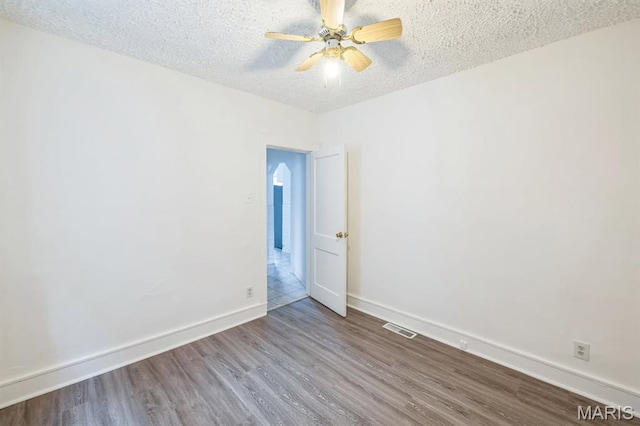 4931 Mardel Ave, Saint Louis, MO 63109 - spare room featuring wood finished floors, ceiling fan, baseboards, and a textured ceiling