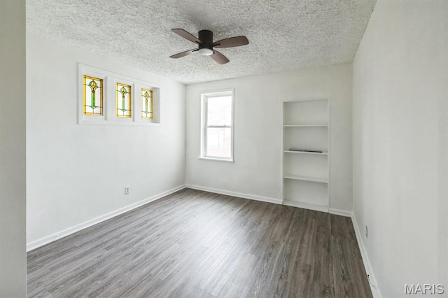 4931 Mardel Ave, Saint Louis, MO 63109 - empty room with a textured ceiling, ceiling fan, wood finished floors, baseboards, and built in shelves